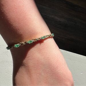 Emerald and diamond gold finished tennis bracelet.